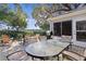 Outdoor patio with seating, dining table, and garden views at 8194 Se 177Th Winterthur Loop, The Villages, FL 32162