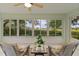Bright sunroom with tiled floors and scenic views at 8194 Se 177Th Winterthur Loop, The Villages, FL 32162