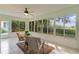 Bright sunroom with tiled floors and scenic views at 8194 Se 177Th Winterthur Loop, The Villages, FL 32162