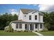 Charming two-story home featuring white siding, a well-manicured lawn, and lush landscaping at 10552 Pearson Ave, Orlando, FL 32827