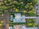 Overhead aerial view of a modern home featuring a backyard pool, manicured lawns, and a spacious driveway at 16909 Crete Way, Bella Collina, FL 34756