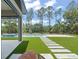 Lush backyard with a pool, spa, and artificial turf, perfect for outdoor entertaining and relaxation at 16909 Crete Way, Bella Collina, FL 34756