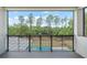 Open-air balcony offering views of the backyard pool and surrounding trees at 16909 Crete Way, Bella Collina, FL 34756
