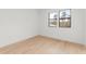 Bright bedroom with hardwood floors and large windows overlooking the trees at 16909 Crete Way, Bella Collina, FL 34756