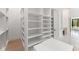 Large walk-in closet with custom shelving, drawers, and ample storage at 16909 Crete Way, Bella Collina, FL 34756