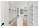 Spacious walk-in closet with custom shelving, drawers, and ample storage at 16909 Crete Way, Bella Collina, FL 34756