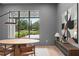 Dining room features modern lighting, elegant wooden table, and large window with beautiful view at 16909 Crete Way, Bella Collina, FL 34756