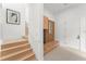 Bright entryway with modern staircase, beautiful storage cabinet and white walls at 16909 Crete Way, Bella Collina, FL 34756