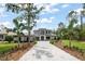 Elegant two-story home featuring a paver driveway, well-maintained landscaping, and attached three-car garage at 16909 Crete Way, Bella Collina, FL 34756