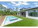 Modern home featuring a pool, spa, manicured lawn, and stylish outdoor living spaces for relaxation and entertainment at 16909 Crete Way, Bella Collina, FL 34756