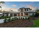 Gorgeous home featuring a three-car garage and a meticulously maintained front yard at 16909 Crete Way, Bella Collina, FL 34756