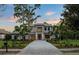 Charming two-story home with manicured landscaping, stone driveway, and a welcoming entrance at 16909 Crete Way, Bella Collina, FL 34756
