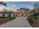 Stunning two-story home boasts an inviting front exterior with a spacious driveway and manicured landscaping at 16909 Crete Way, Bella Collina, FL 34756