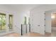 Hallway space with access to balcony and several rooms featuring sleek black railings and neutral walls at 16909 Crete Way, Bella Collina, FL 34756
