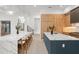 A chef's kitchen showcases double islands with quartz countertops, barstool seating, and custom wood cabinetry at 16909 Crete Way, Bella Collina, FL 34756