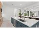 Open concept kitchen with views of a fireplace and dining area featuring double islands, quartz countertops, and modern cabinetry at 16909 Crete Way, Bella Collina, FL 34756