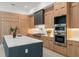 Modern kitchen features custom wood cabinets, a stainless steel appliance suite, and quartz countertops on the double islands at 16909 Crete Way, Bella Collina, FL 34756