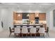 Open-concept kitchen and dining area with custom cabinetry and modern lighting at 16909 Crete Way, Bella Collina, FL 34756