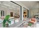 Open-plan living space with a modern seating area, seamless indoor-outdoor flow, and a glimpse of the kitchen at 16909 Crete Way, Bella Collina, FL 34756