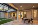 A stylish outdoor patio featuring an outdoor living and dining area with seamless indoor/outdoor flow at 16909 Crete Way, Bella Collina, FL 34756