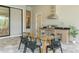 Outdoor dining and kitchen area with a glass table and stainless steel appliances at 16909 Crete Way, Bella Collina, FL 34756
