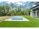 Backyard pool and spa with clear blue water and lush green surroundings, perfect for outdoor enjoyment at 16909 Crete Way, Bella Collina, FL 34756