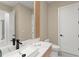 Stylish powder room featuring modern fixtures, a unique mirror and a sleek design at 16909 Crete Way, Bella Collina, FL 34756