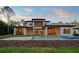 Impressive backyard with a sparkling pool, lush lawn, and stylish outdoor living spaces at 16909 Crete Way, Bella Collina, FL 34756