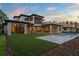 Expansive backyard featuring a pool, manicured lawn, and an outdoor kitchen perfect for entertaining at 16909 Crete Way, Bella Collina, FL 34756