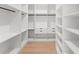 Spacious walk-in closet with custom shelves, drawers, and hanging rods provides ample storage at 16909 Crete Way, Bella Collina, FL 34756