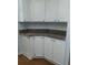 Kitchen cabinetry featuring white cabinets, granite countertops, and chrome hardware at 1704 Pebble Beach Ln, Lady Lake, FL 32159