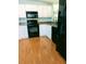 Classic kitchen featuring white cabinets, granite countertops, and black appliances at 1704 Pebble Beach Ln, Lady Lake, FL 32159