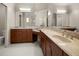 Bright bathroom features double vanities with marble countertops, tile floors, and large mirrors at 210 Westcott Ct, Deland, FL 32724