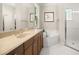 Well-lit bathroom featuring a corner tub, glass shower and a vanity with marble countertop at 210 Westcott Ct, Deland, FL 32724