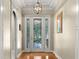 Inviting foyer featuring a decorative glass door, hardwood floors, and elegant lighting at 210 Westcott Ct, Deland, FL 32724