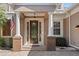 Elegant front entrance with decorative glass door, stately columns and brick accents at 210 Westcott Ct, Deland, FL 32724