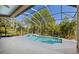 Enclosed in-ground pool with screened enclosure, tiled waterfall, and ample deck space at 210 Westcott Ct, Deland, FL 32724