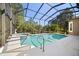 Inviting screened-in pool and spa with lush landscaping at 210 Westcott Ct, Deland, FL 32724