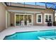 Covered patio area overlooking an in-ground pool, outdoor seating, and a grill at 210 Westcott Ct, Deland, FL 32724