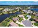 Aerial view showcasing the home's location within a beautiful community with lakes at 25611 Maurepas Ln, Leesburg, FL 34748