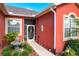 Inviting front entrance with a charming pineapple fountain and decorative welcome screen door at 25611 Maurepas Ln, Leesburg, FL 34748