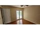 Bedroom with wood floors, pool view, and french doors at 7807 Rollingridge Ct, Orlando, FL 32835