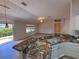 Spacious kitchen with granite countertops transitions seamlessly into the living area at 3425 Dixon Ln, The Villages, FL 32162