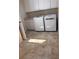 Neat laundry room featuring side-by-side washer and dryer with overhead cabinets at 3425 Dixon Ln, The Villages, FL 32162