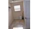 Small utility room with window for ventilation, tiled flooring, and storage space at 3425 Dixon Ln, The Villages, FL 32162