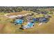 Aerial shot of community amenities with pools, parking and a golf course surrounded by lush green landscape and trees at 4088 Kingsley St, Clermont, FL 34711