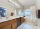 Bathroom with double sink vanity, large mirror, and separate tub at 4088 Kingsley St, Clermont, FL 34711