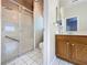 Bright bathroom featuring a glass enclosed shower and a single sink vanity with ample storage at 4088 Kingsley St, Clermont, FL 34711