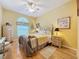 Cozy bedroom with wood floors, ceiling fan, and window with blinds dressed with valance at 4088 Kingsley St, Clermont, FL 34711