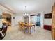 Formal dining room with chandelier, tile flooring, and sliding glass door to patio at 4088 Kingsley St, Clermont, FL 34711